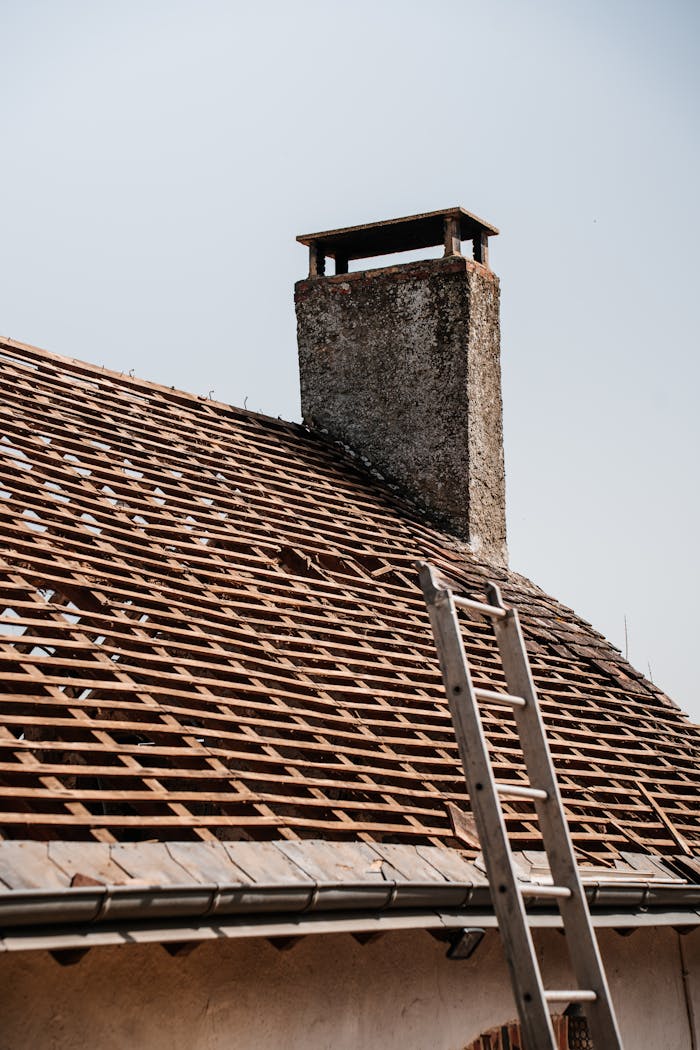The Art of Drawing Readers In: Your attractive post title goes here A traditional rooftop under renovation with visible chimney and ladder.
