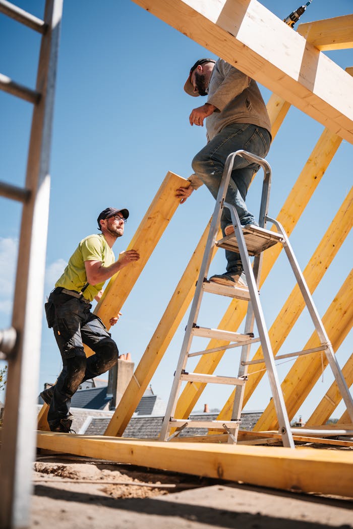 Crafting Captivating Headlines: Your awesome post title goes here Two construction workers building a wooden roof structure on a sunny day.